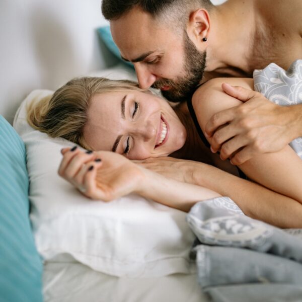 Happy Couple Cuddling in Bed in Morning