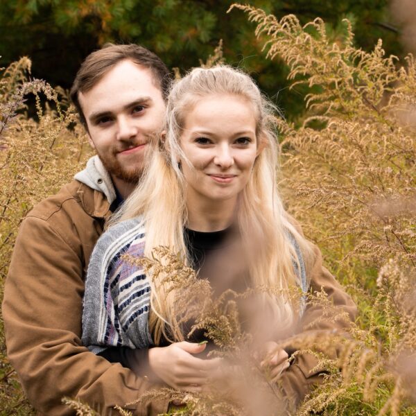 shallow focus photo of man hugging woman