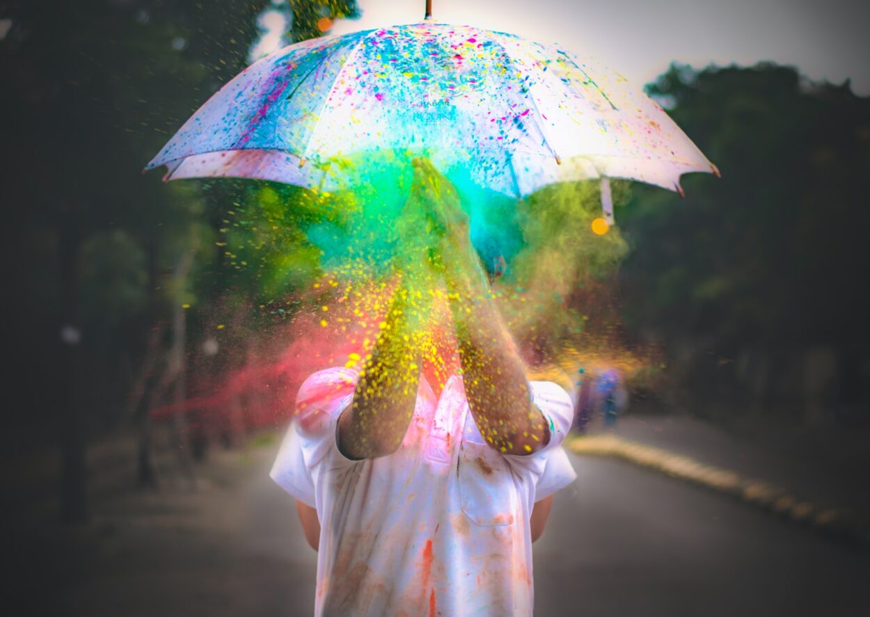 person in pink dress holding umbrella