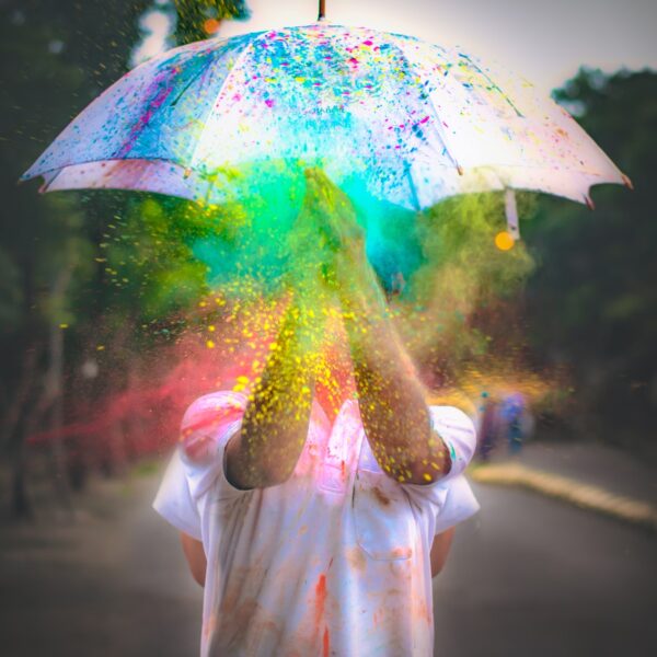 person in pink dress holding umbrella